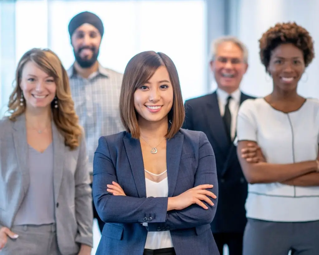 Photo of five corporate employees smiling
